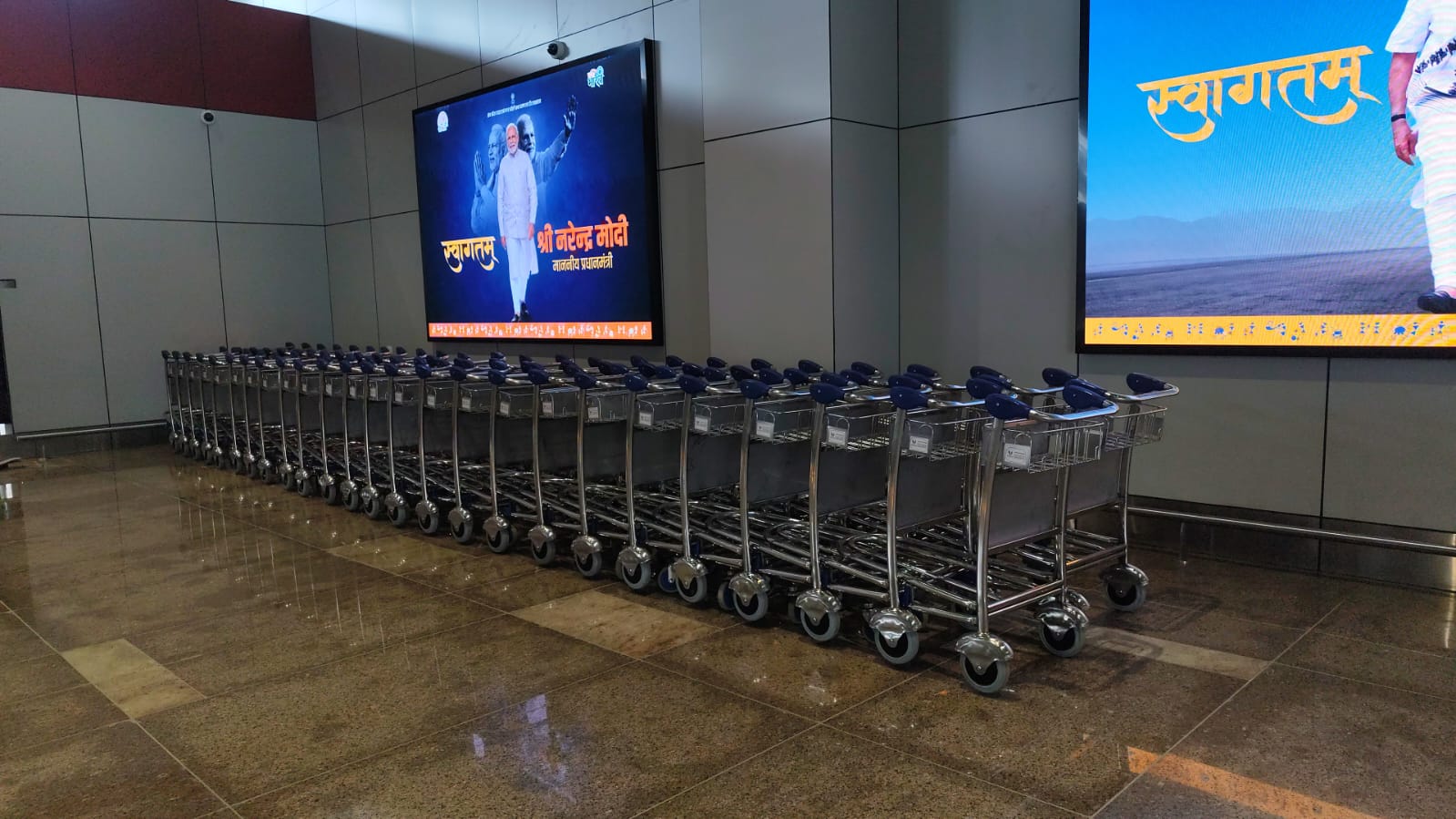 Airport luggage trolleys lined up at terminal arrival hall Perfecctio Enterprises